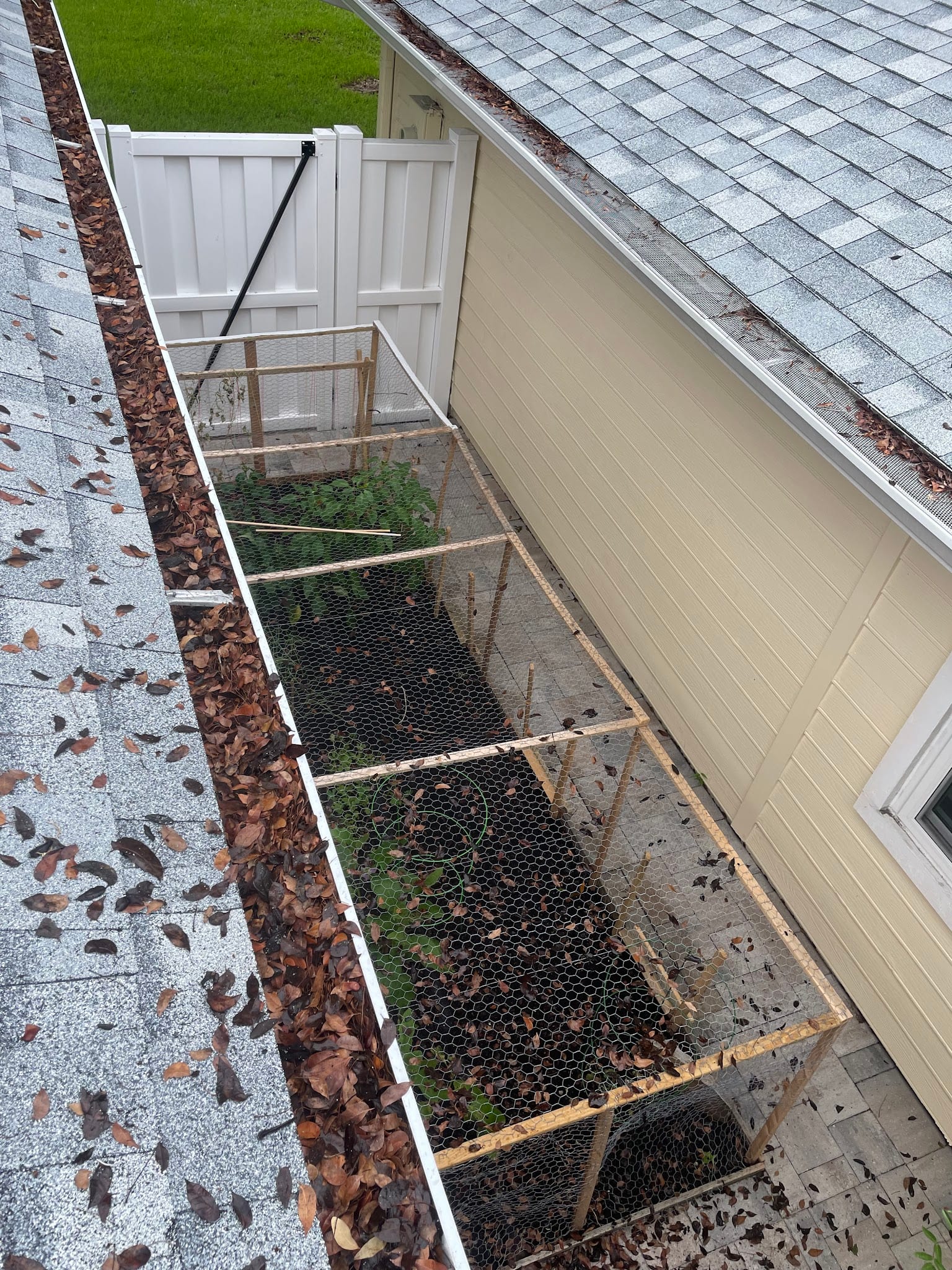 Gutters filled with fallen leaves alongside a garden enclosure in Port Charlotte.