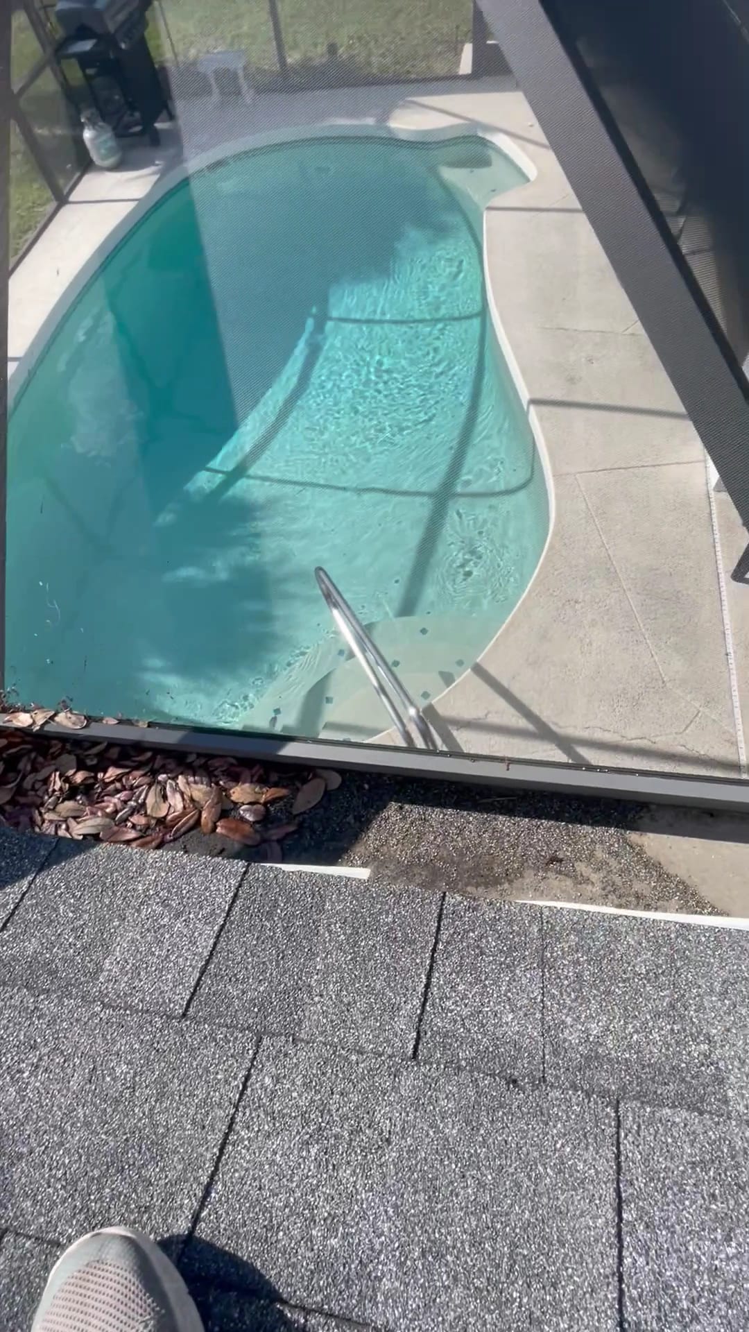 Clogged gutters with debris near screened pool enclosure in Port Charlotte