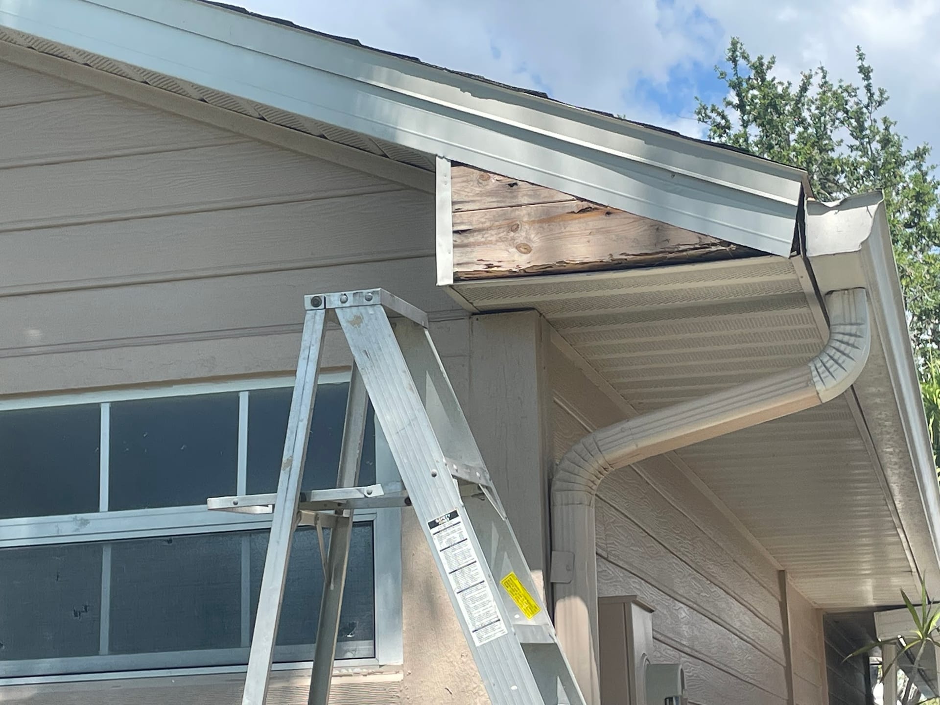 Rotted fascia board exposed during gutter repair on Port Charlotte home